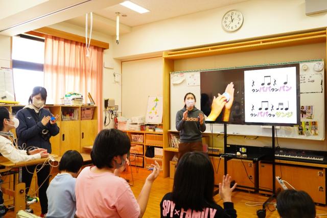 画像：障害のある子供たちにカスタネットの授業をする女性教諭